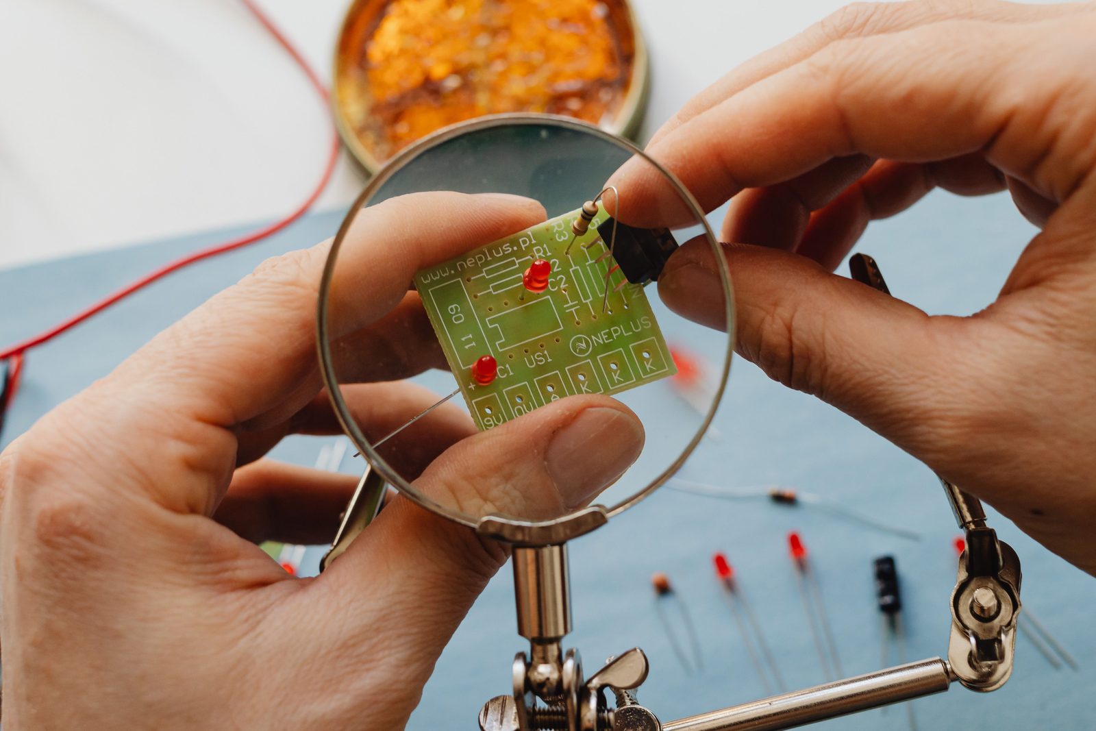 Assembling a circuit board at the bench.